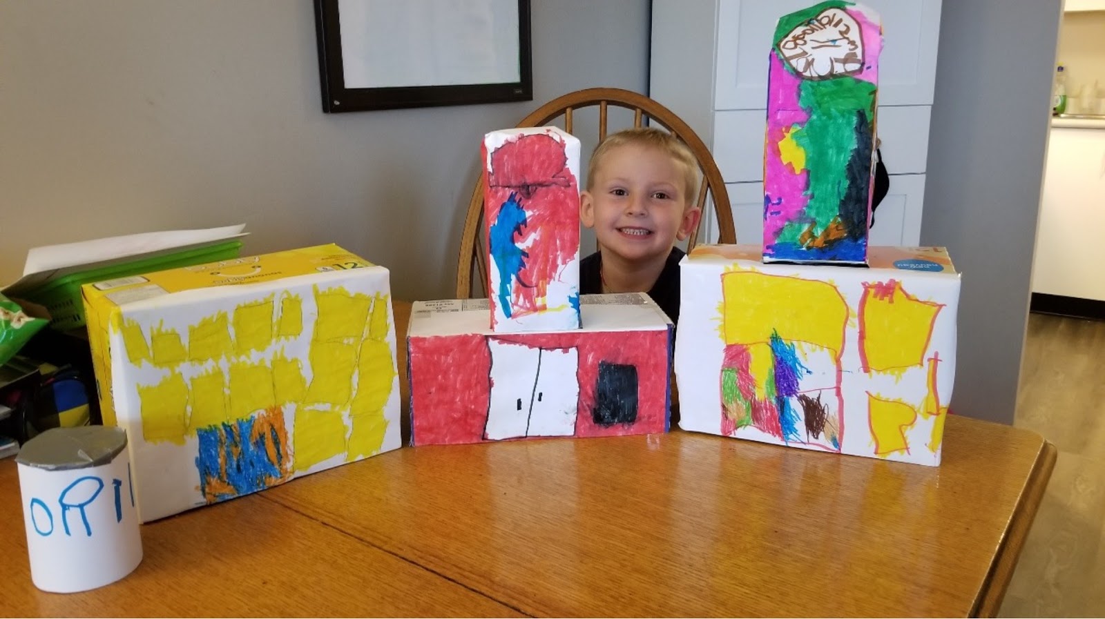 Child displays creation after going on virtual field trip