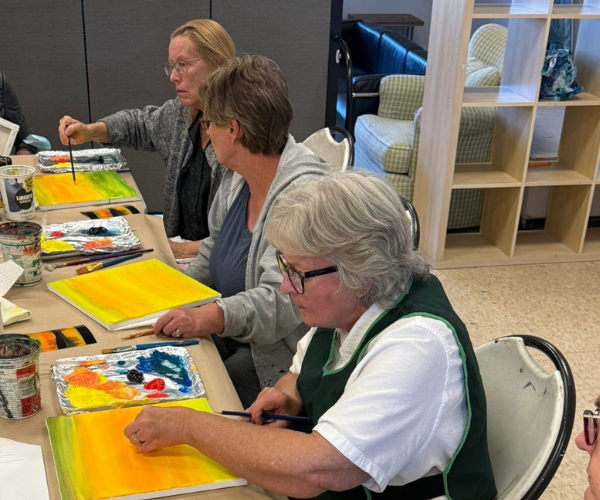 Seniors creating artwork together during an art program at OMAH