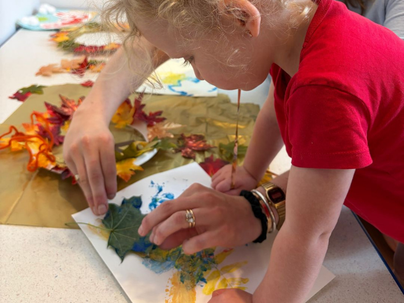 Child enjoying a hands-on fall craft during Family Discovery Days at OMAH in Orillia.